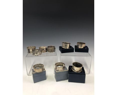 EIGHT VARIOUS HALLMARKED SILVER NAPKIN RINGS TOGETHER WITH A HALL &amp; BARTON BANGALORE NAPKIN RING. WEIGHT 193g