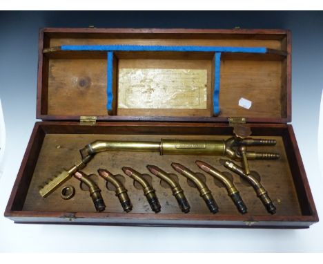 A BRITISH OXYGEN COMPANY BOXED UNIVERSAL BLOWPIPE WITH SEVEN COPPER TIPPED BRASS HEADS, THE STAINED PIPE BOX.   W 50cms.