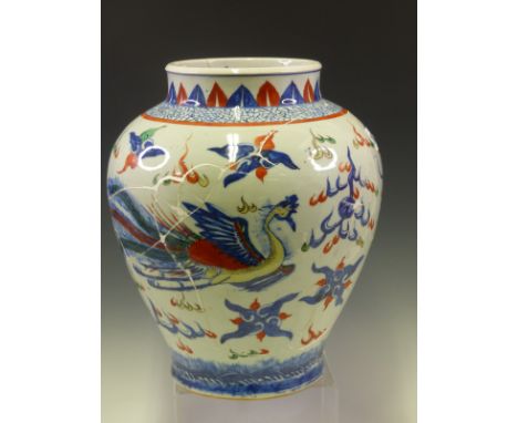 A CHINESE FAMILLE VERTE BALUSTER JAR PAINTED WITH A DRAGON AND A PHOENIX HEAD TO HEAD WITH A FLAMING PEARL.   H 30cms.  TOGET