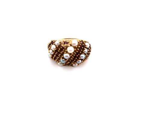 A GARNET AND PEARL NINE ROW BOMBE RING. THE INSIDE SHANK STAMPED 14K, ASSESSED AS 14ct GOLD. FINGER SIZE K. WEIGHT 8.5grms. 