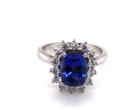 A HALLMARKED PLATINUM TANZANITE AND DIAMOND CLUSTER RING. APPROX SAPPHIRE MEASUREMENTS 9.5 X 7.4mm. FINGER SIZE Q. WEIGHT 8.6