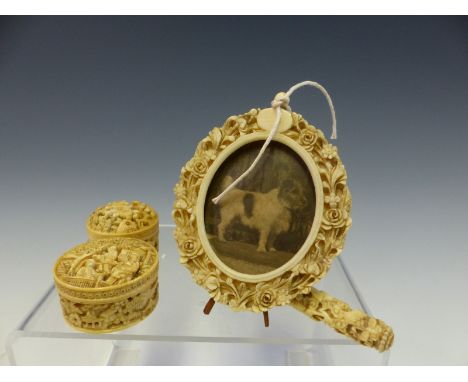 A CHINESE IVORY FLORAL CARVED OVAL EASEL BACKED FRAME.   H 10cms. A DRAGON CARVED NEEDLE CASE TOGETHER WITH TWO CARVED IVORY 