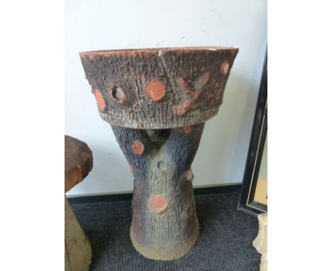 A TERRACOTTA BIRD BATH IN THE FORM OF A TREE TRUNK 