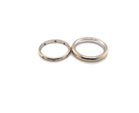 A DIAMOND SET WEDDING RING AND ONE OTHER. BOTH UNHALLMARKED ONE STAMPED 14KT, THE OTHER 10K. BOTH ASSESSED AS 14 AND 10ct WHI