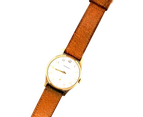 A VINTAGE GARRARD MANUAL WOUND PRESENTATION WATCH. THE REVERSE ENGRAVED PRESENTED TO B.ELLIS BY LONDON BRICK COMPANY LTD. IN 