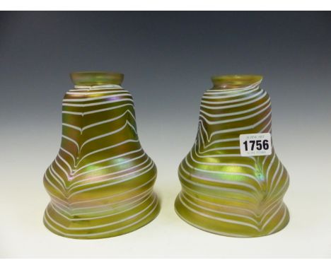 A PAIR OF GREEN IRIDESCENT GLASS LIGHT SHADES TRAILED HORIZONTALLY IN WHITE.   H 16.5cms. 
