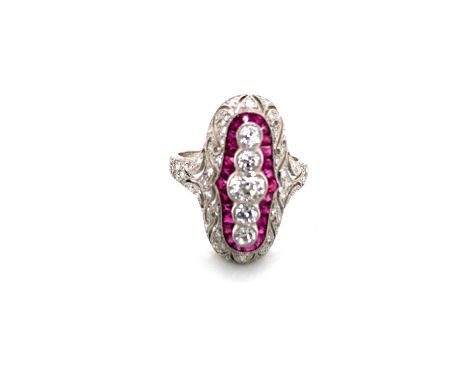 A RUBY AND DIAMOND ART DECO STYLE PANEL RING. FIVE OLD CUT GRADUATED DIAMONDS SURROUNDED BY A FRAME OF FANCY CUT BRIGHT RUBIE