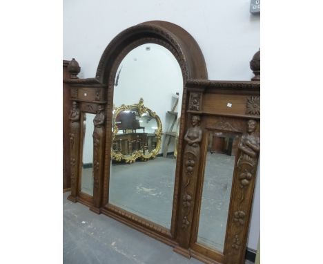 A VICTORIAN TRIPLE PLATE BEVELLED GLASS MIRROR, THE CENTRAL ROUND ARCH OF THE OAK FRAME FLANKED BY ACORN FINIALS AND RAISED A