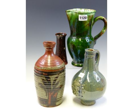 A STUDIO POTTERY BLUE GLAZED BELLARMINE, A GREEN GLAZED JUG. A BROWN STONE WARE VASE BY J H R AND THE TALLEST A THREE COLOUR 