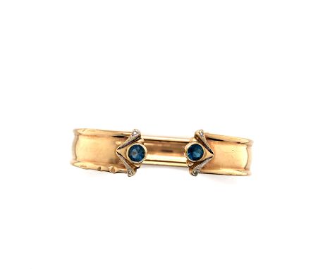 A 9ct HALLMARKED GOLD BLUE TOPAZ AND DIAMOND CUFF BANGLE. INTERNAL DIAMETER 6cms. WEIGHT 10.28grms. 