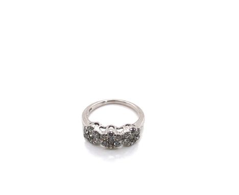 A THREE CLUSTER DIAMOND TRILOGY RING. UNHALLMARKED, STAMPED 750, ASSESSED AS 18ct WHITE GOLD. FINGER SIZE K. WEIGHT 3.57grms.