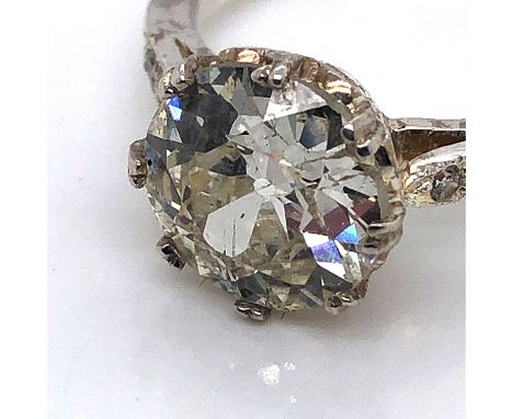 AN OLD CUT DIAMOND SINGLE STONE RING IN A DOUBLE EIGHT CLAW MOUNT UPON DIAMOND SET SHOULDERS. UNHALLMARKED, ASSESSED AS PLATI