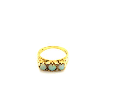 AN 18ct HALLMARKED GOLD THREE STONE GRADUATED OPAL AND DIAMOND CARVED HALF HOOP RING, DATED 1989, LONDON. FINGER SIZE O. WEIG