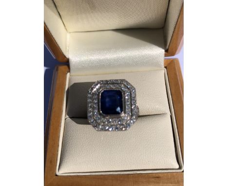 A SAPPHIRE AND DIAMOND ART DECO STYLE RING. THE SAPPHIRE APPROX TOTAL WEIGHT 2.45cts, DIAMOND WEIGHT APPROX 0.75cts. UNHALLMA