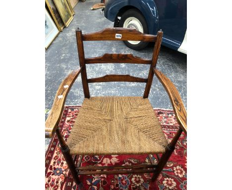 A LEATHER UPHOLSTERED ARM CHAIR, AN OAK LADDER BACKED CLISSETT TYPE ELBOW CHAIR WITH A RUSH SEAT AND A COUNTRY CHAIR WITH A T