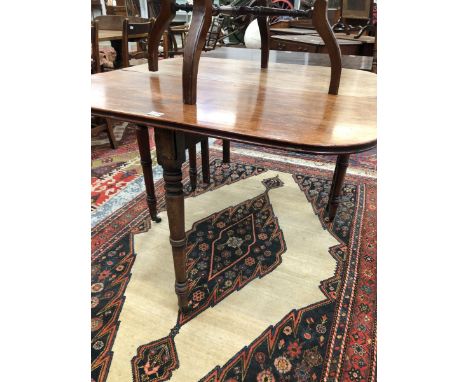 A 19th C. MAHOGANY TEA TABLE. THE ROUNDED RECTANGULAR TOP OPENING ON A SINGLE GATE, THE RING TURNED CYLINDRICAL LEGS TAPERING