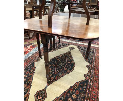 A 19th C. MAHOGANY TEA TABLE. THE ROUNDED RECTANGULAR TOP OPENING ON A SINGLE GATE, THE RING TURNED CYLINDRICAL LEGS TAPERING