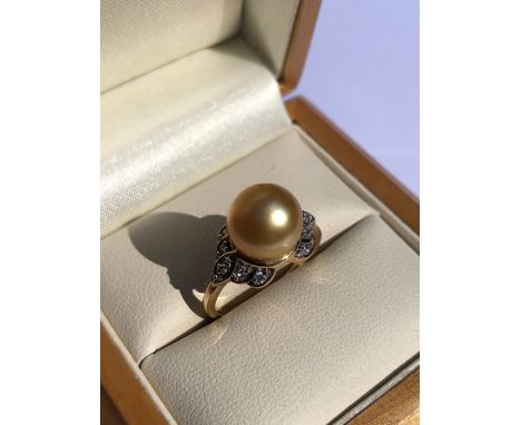 A HALLMARKED 9ct GOLD GOLDEN SOUTH SEA PEARL AND WHITE ZIRCON DRESS RING. PEARL APPROX 9mm. FINGER SIZE L 1/2. WEIGHT 3.79grm