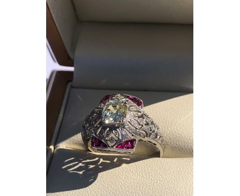 AN OLD CUT DIAMOND AND FANCY CUT RUBY ART DECO STYLE OPEN WORK RING. UNHALLMARKED, STAMPED PLAT, ASSESSED AS PLATINUM. FINGER