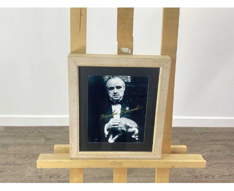MARLON BRANDO SIGNED PICTURE PORTRAIT with signature across the front, framed and under glass32.5cm wide x 38cm high