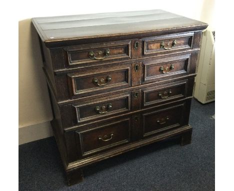 A large Georgian oak chest of four drawers on bracket feet with brass handles. Est. £150 - £200.