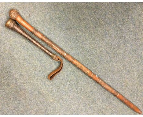 A good tapering leather truncheon / mallet together with a carved walking stick of Oriental design. Est. £30 - £50.