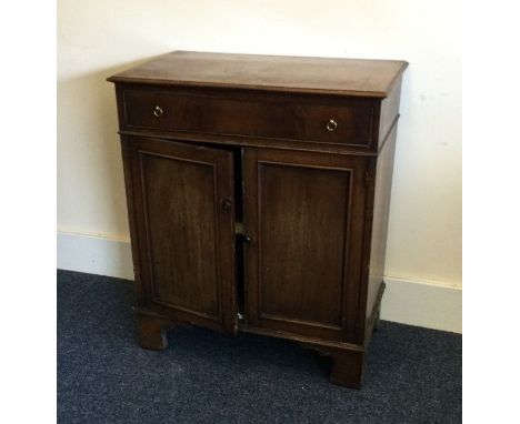 A Georgian mahogany two door cupboard with single drawer on bracket feet. Est. £50 - £80.