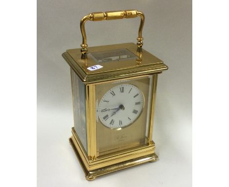 A large heavy brass mounted carriage clock. By James of London. Est. £60 - £80.