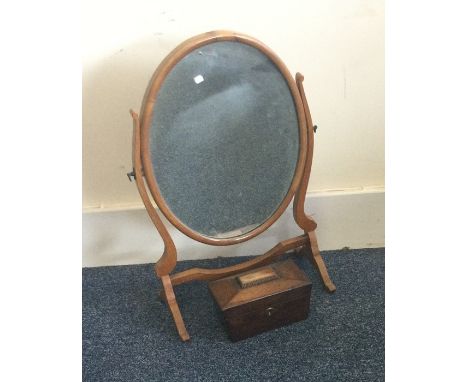 An Edwardian mahogany mirror together with a tea caddy. Est. £20 - £30.
