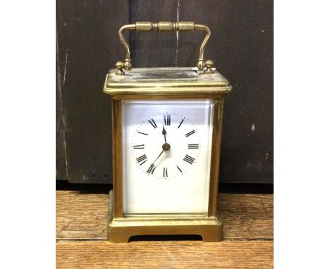 A brass mounted carriage clock on bracket feet with white enamelled dial. Est. £20 - £30.