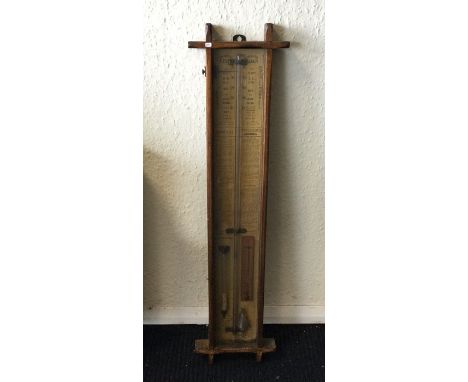 An oak cased barometer of stylised form. Est. £50 - £80.