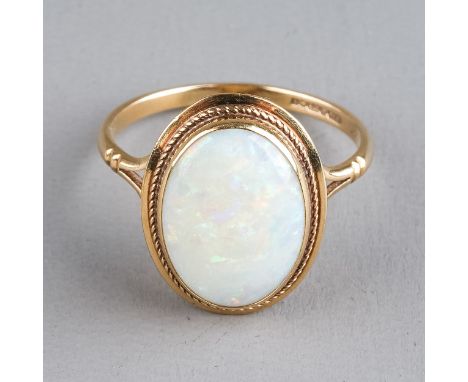 A 9ct yellow gold opal ring, set with an oval cabochon stone, ring size O, total gross weight approx 2.4g  Good condition, we