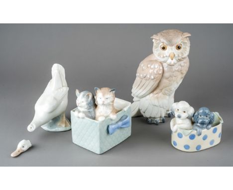 A group of four Nao figures to include: Puppies in basket no: 1082; Cats in a box, no: 1080; Owl no: 712 and Goose no: 244, a