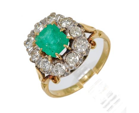 An 18ct yellow gold emerald and diamond cluster ring, the step-cut emerald surrounded by ten round diamonds, total diamond we