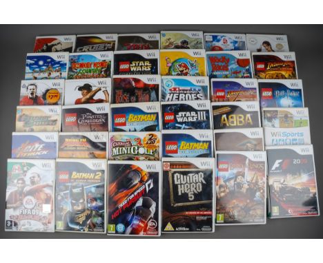 A Nintendo Wii games console, various controllers, accessories and 35 assorted boxed / cased games to include: The Legend of 
