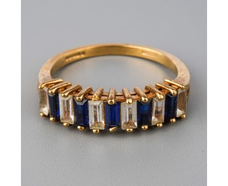 A 9ct yellow gold ring, set with alternating blue and white stones possibly spinel, size O, total gross weight approx 3g  Gen
