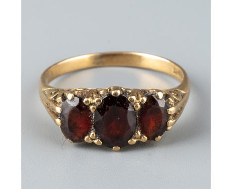 A 9ct yellow gold and garnet dress ring, set with three oval cut stones, ring size O, total gross weight approx 2.7g  Stones 