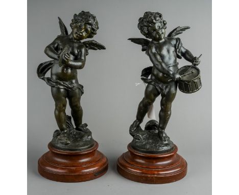 A pair of French decorative bronzed spelter figures of cherubs playing the cymbals or drum, on painted wooden bases, the figu