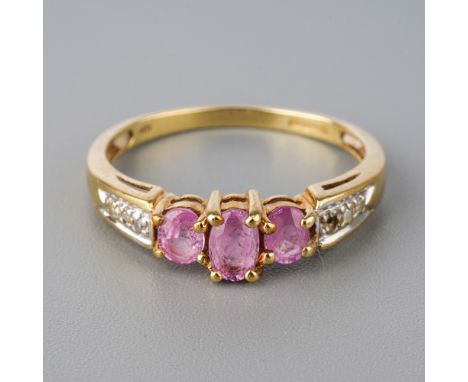 A 9ct yellow gold pink sapphire ring, three oval mixed-cut sapphires, diamond chips to shoulders, size Q, total gross weight 