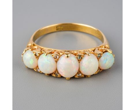 An 18ct yellow gold opal five-stone ring, set with graduated cabochon opals, diamond highlights, size Q, total gross weight a