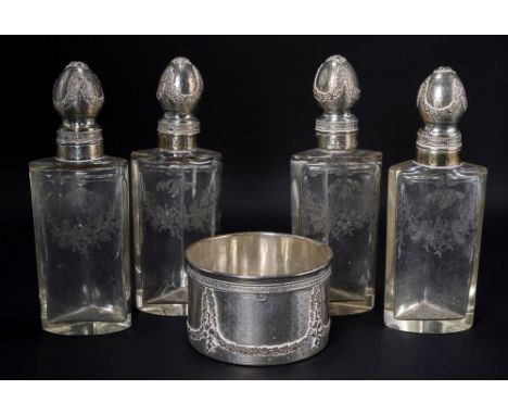 A set of four French silver-mounted engraved glass scent-bottles, first quarter 20th Century, the four bottles formed to fit 
