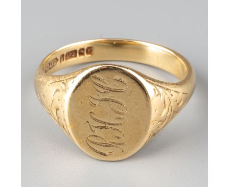 A 9ct yellow gold gentleman's signet ring, oval monogrammed head with chased foliate shoulders, ring size U1/2, Birmingham ha