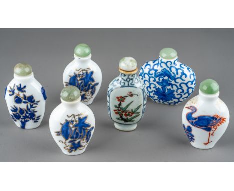 A collection of Chinese porcelain snuff bottles, including a pair of ovoid bottles enameled with blue flowers, gilt highlight