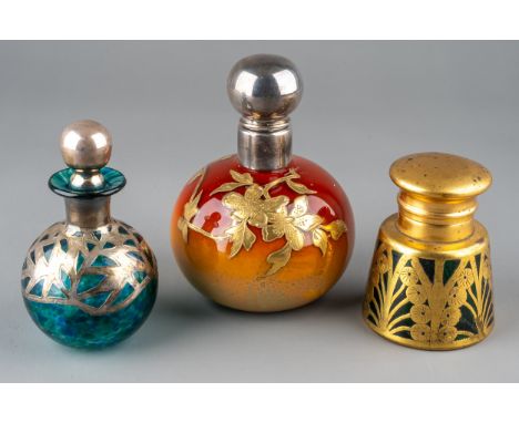 A globular coloured glass scent bottle, in tones of burnt orange and yellow, applied with foliate gilt decoration, white meta
