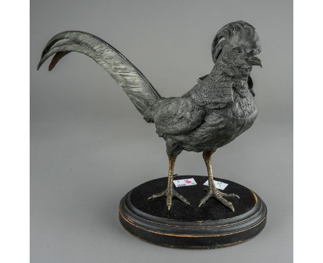 An early 20th Century large patinated spelter inkwell modelled as a rooster, the head and neck hinged to reveal ceramic inkwe