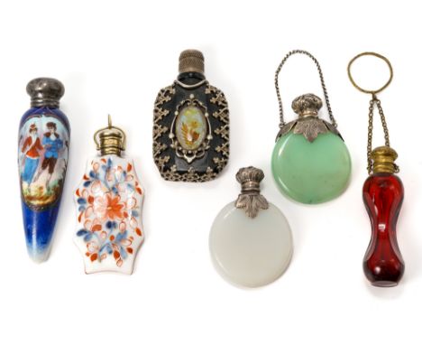 A collection of six miniature scent bottles including; a 19th century red glass bottle with gilt metal hinged cover, chain an