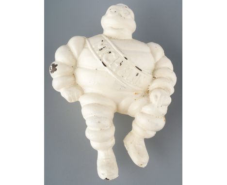 A vintage cast Michelin man, seated wearing Michelin sash, approx 11.5cm long  