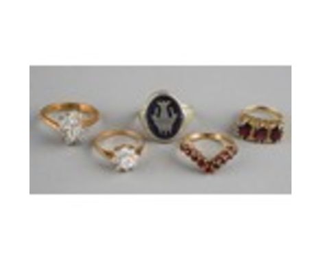 A 9ct yellow gold and garnet three stone ring, size I, approx 3.1g; a 9ct gold and garnet wishbone ring, size L, approx 2.9g;