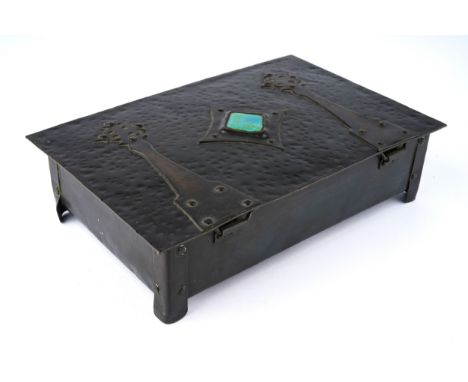 An Arts and Crafts rectangular copper box, the hammered cover with strapwork hinges, central raised Ruskin style ceramic moun