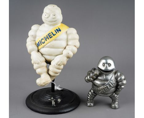 A cast metal model of a revolving Michelin man, with yellow sash, approx 30cm high and a chrome model of Michelin man, sash t